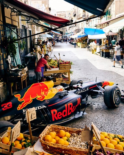 Max, driving the RB7 through a street market.
