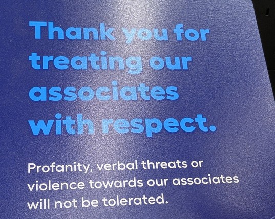 Sign that says "Thank you for treating our associates with respect. Profanity, verbal threats, or violence towards our associates will not be tolerated."