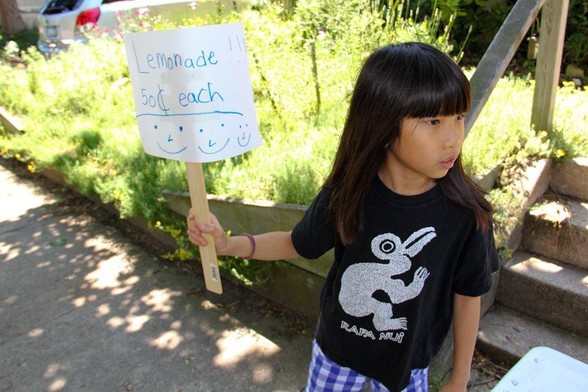 market conference schedule: photograph of a young girl holding a paper sign that says "Lemonade 50¢ each". Photo attribution: Flickr user stevendepolo