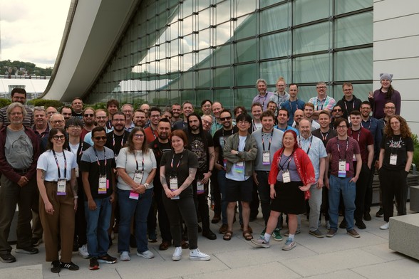 A large group of Python core developers and contributors at Python Language Summit 2025, outdoor at David L. Lawrence convention center