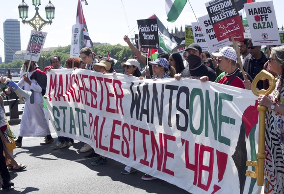 large banner carried by people marching: Manchester wants one state Palestine '48!