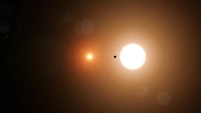 Image of two stars, one small and a dull orange, one larger and a bright yellow. In between is a small dark object.