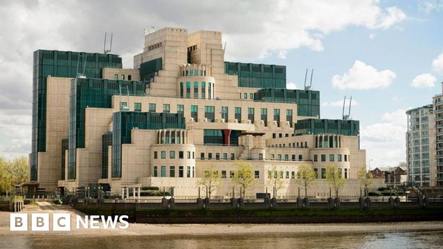 The headquarters for the British Secret Intelligence Services in London. It has has numerous levels that increase in size. It has white walls and blue glass windows.