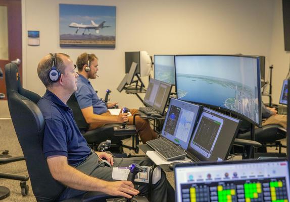 Andy Burroughs (left) and Paul Friz in the roles of air taxi pilots running through air taxi integration simulations focusing on urban air space at NASA’s Langley Research in Hampton, Virginia on Sept. 25, 2024.
