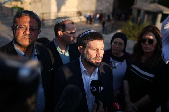 Member of the Knesset (Israel's parliament) from religious Zionist parties, Bezalel Smotrich speaks to a journalist as fellow Knesset member Itamar Ben Gvir (left) looks on, outside the Damascus Gate in Jerusalem, on October 20, 2021.