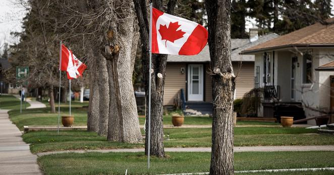Canadian flags line a street in High River, Alta., Wednesday, May 7, 2025. THE CANADIAN PRESS/Jeff McIntosh