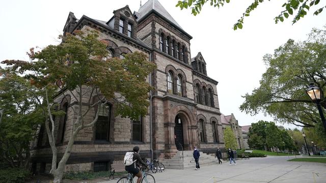 People traverse Brown University campus in Providence, R.I., Oct. 12, 2020. (AP Photo/Steven Senne, File)