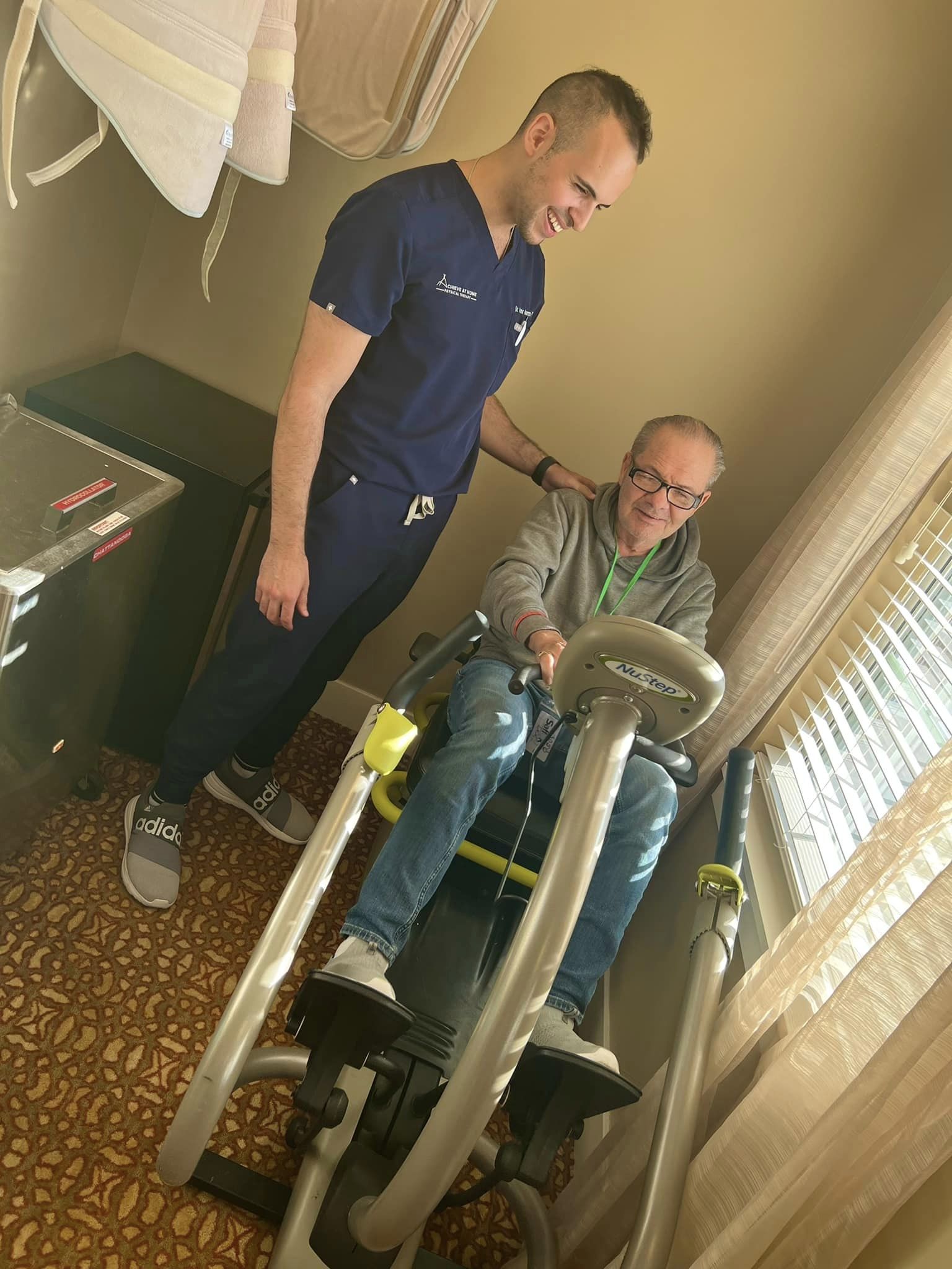 What is sub acute rehab? A physical therapist helping a senior bike on a stationary sit-down bicycle